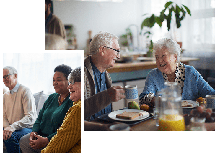 Older adults sitting together indoors, smiling and engaging in conversation, with a breakfast table set with food and drinks in a bright, cozy environment.